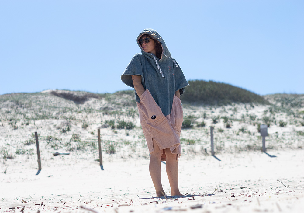 A girl with an organic poncho at the beach